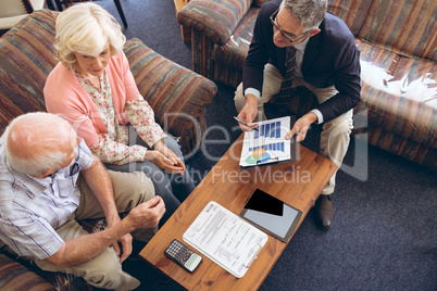 Physician showing medical statistics to senior couple