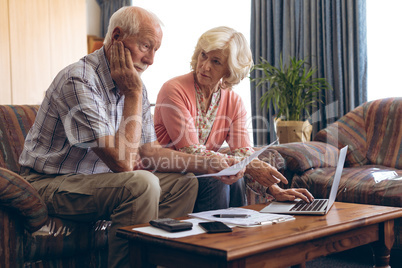 Couple discussing bill at retirement home