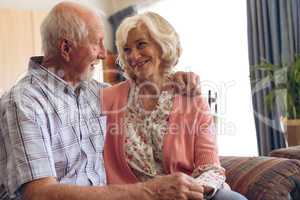 Couple sitting on sofa at retirement home