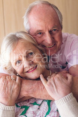 Couple posing while looking at camera at retirement home