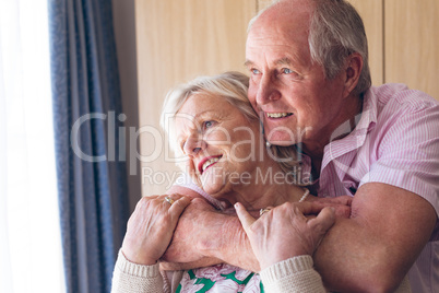 Couple posing while standing  at retirement home