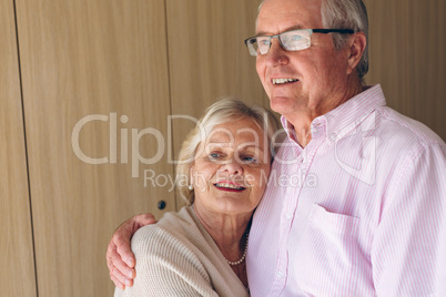 Couple posing while standing  at retirement home
