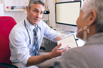 Male doctor and senior woman interacting with each other