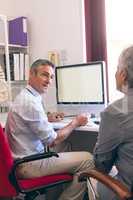 Male doctor and senior woman interacting with each other