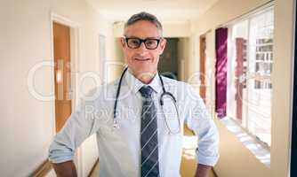 Male doctor standing at retirement home