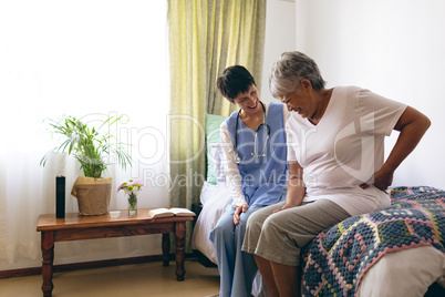 Female doctor and senior female patient interacting