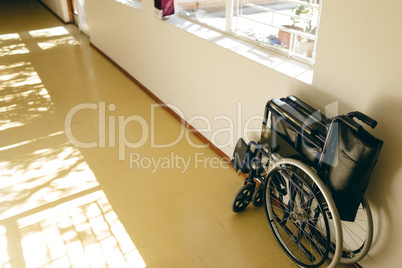 Empty wheelchair against wall at retirement home