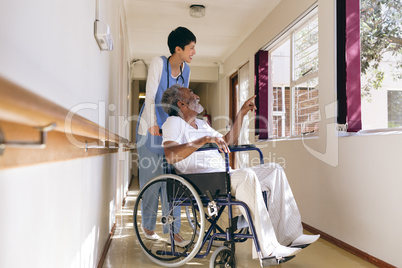 Female nurse and senior male patient interacting