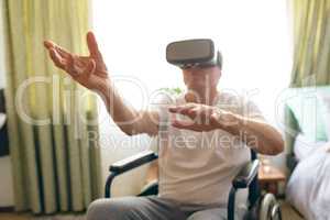 Senior male patient using virtual reality headset at retirement home