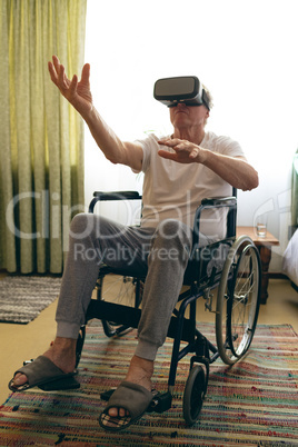 Senior male patient using virtual reality headset at retirement home