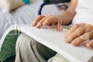 Senior male patient is reading in a retirement home