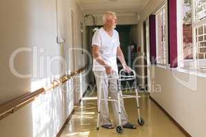 Senior male patient standing with walker