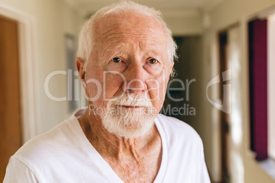 Senior male patient standing in corridor