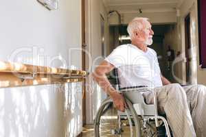 Senior male patient sitting on wheelchair at retirement home