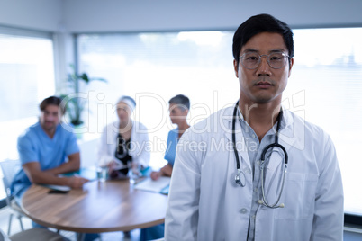 Smart doctor standing in hospital