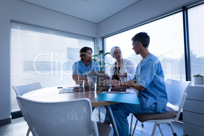 Doctor and surgeon discussing over laptop in clinic at hospital