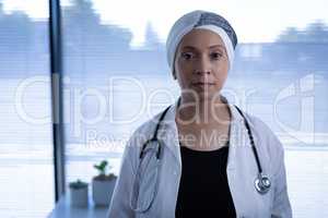 Matured female doctor standing in clinic at hospital