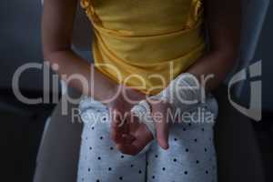 Girl sitting with fractured hand in clinic at hospital