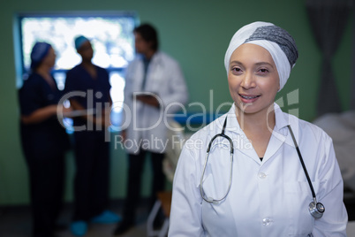 Matured female doctor smiling in clinic at hospital