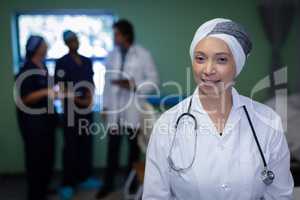 Matured female doctor smiling in clinic at hospital