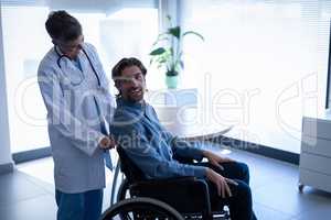 Female doctor talking with disabled patient in clinic at hospital