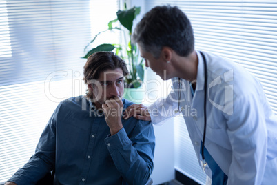 Female doctor talking with disabled patient in clinic at hospital