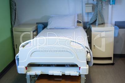 Empty bed and cabinet in hospital