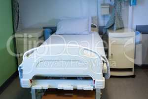 Empty bed and cabinet in hospital