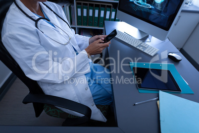 Doctor using mobile phone in clinic at hospital