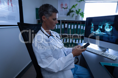 Female doctor using smart phone in clinic at hospital