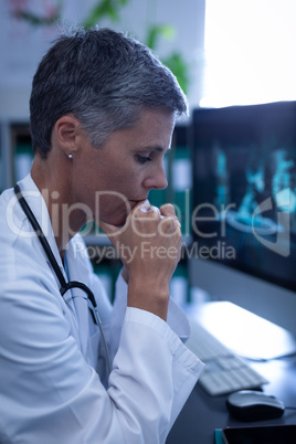 Female doctor sitting upset in clinic at hospital