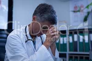Female doctor sitting upset in clinic at hospital