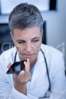 Female doctor talking on mobile phone in clinic at hospital