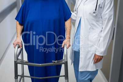 Mature female doctor and senior female patient together in clinic