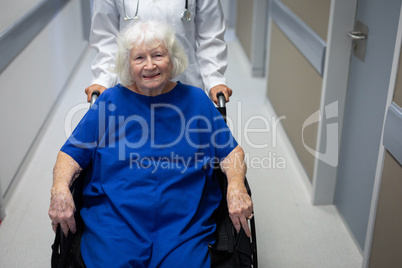 Senior female patient and doctor standing in hospital clinic