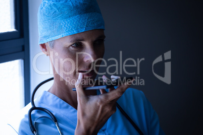 Female surgeon talking on mobile phone at hospital