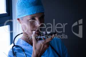 Female surgeon talking on mobile phone at hospital