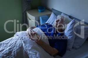 Senior female patient sleeping in a hospital bed