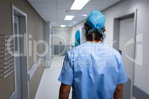 Male surgeon walking through the hospital corridor
