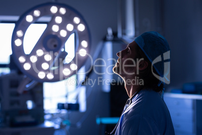 Nervous male surgeon sitting in operation room at hospital