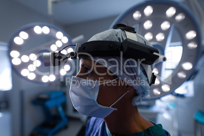 Thoughtful female surgeon standing in operation theater