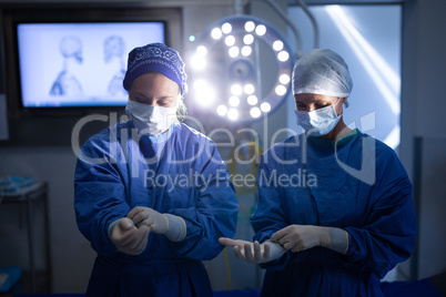 Female surgeons wearing latex gloves before operation