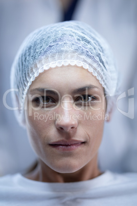 Female surgeon sitting on bed in operation theater