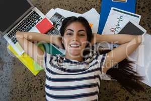 Woman relaxing on documents at office