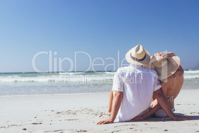Couple relaxing at beach on a sunny day