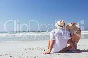 Couple relaxing at beach on a sunny day