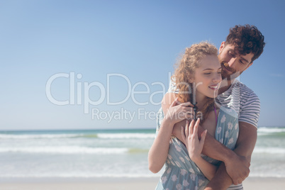 Happy couple standing at beach on a sunny day