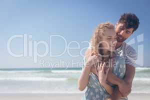 Happy couple standing at beach on a sunny day