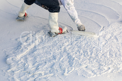 Worker Wearing Spiked Shoes Smoothing Wet Pool Plaster With Trowel