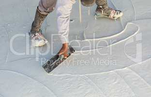 Worker Wearing Spiked Shoes Smoothing Wet Pool Plaster With Trowel